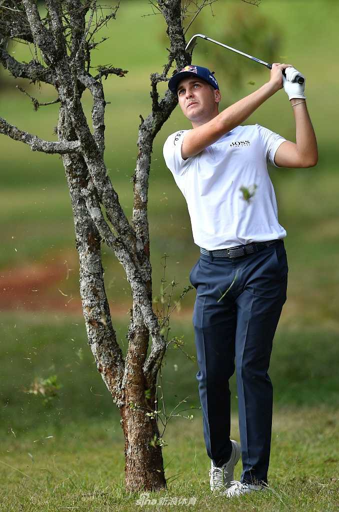高尔夫球在空中划出优美弧线，背景是典型的非洲草原疏林景观